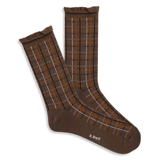 Pair of brown crew socks with orange, white, and black plaid, ruffled cuffs, and 'k.bell' logo on the sole.