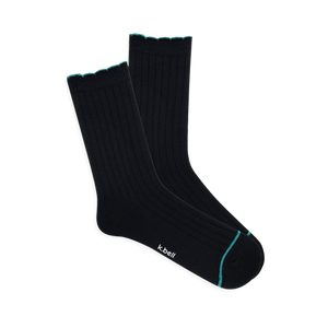 Pair of black ribbed wool blend crew socks with a teal scalloped cuff and a thin teal line on the toe, laid flat.