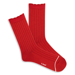 Pair of bright red ribbed wool blend crew socks with a red scalloped cuff and a thin white line on the toe, laid flat.