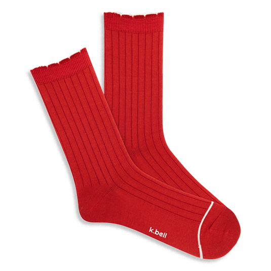 Pair of bright red ribbed wool blend crew socks with a red scalloped cuff and a thin white line on the toe, laid flat.