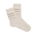 Pair of ribbed, slouchy crew socks in an off-white or cream color, shown on a black background. 'k.bell' logo visible on sole.