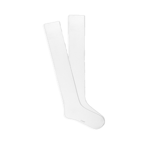 A pair of solid white knee-high socks, laid flat and slightly overlapping, showing the smooth fabric and comfort top.