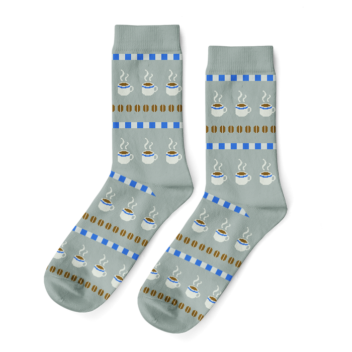 Pair of light grey crew socks with horizontal stripes depicting white coffee cups with steam, brown coffee beans, and blue blocks. }}