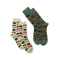 Two pairs of crew socks laid flat. One pair is light green with music patterns, the other is dark green with the same design.