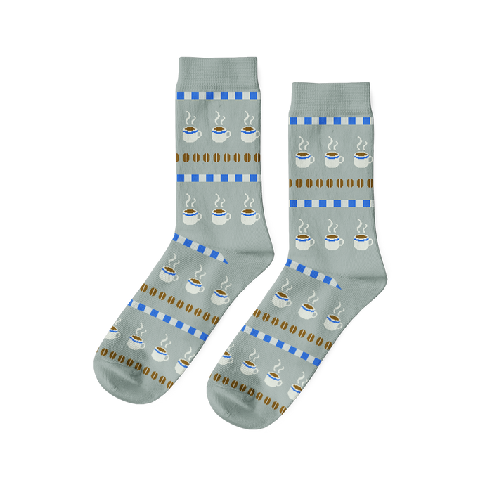 Pair of light grey crew socks with a repeating pattern of steaming coffee cups, brown coffee beans, and blue dashed stripes. }}