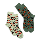 Two pairs of crew socks: one light green and one darker green, both featuring a music record and boombox pattern.