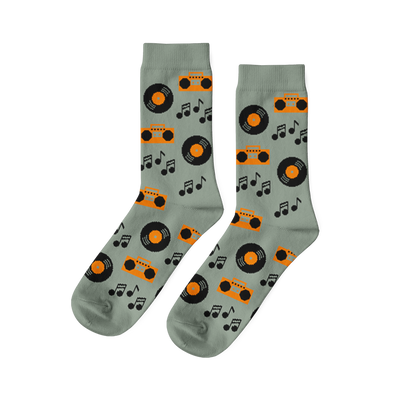 Pair of light green crew socks with a repeating pattern of orange boomboxes, black vinyl records, and music notes.