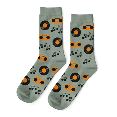 Pair of light green crew socks with a repeating pattern of orange boomboxes, black vinyl records, and music notes.