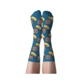 A person's legs wearing blue crew socks with hot dog and pretzel pattern, shown with soles facing up against a dark background.