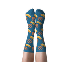 A person's legs wearing blue crew socks with hot dog and pretzel pattern, shown with soles facing up against a dark background.