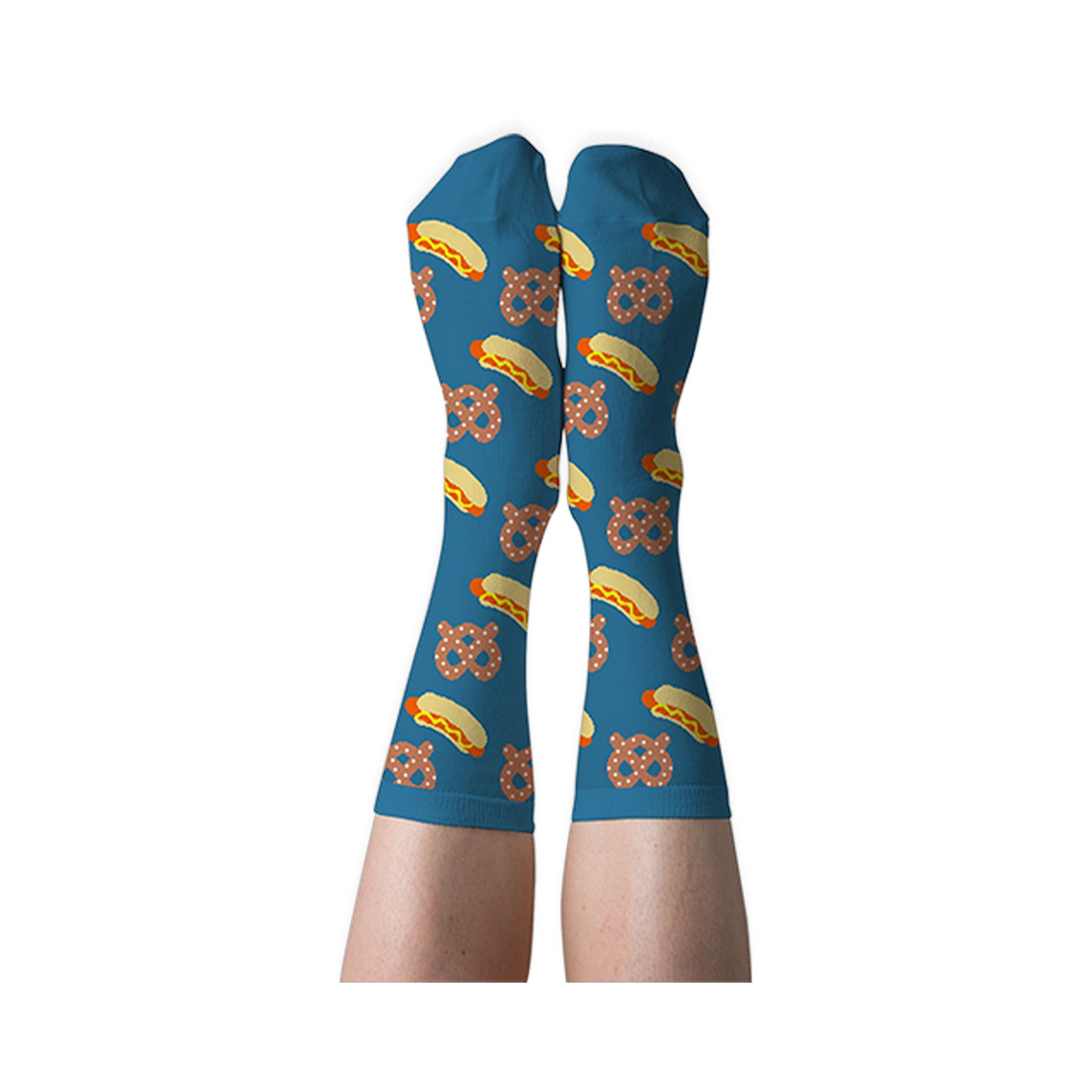 A person's legs wearing blue crew socks with hot dog and pretzel pattern, shown with soles facing up against a dark background.
