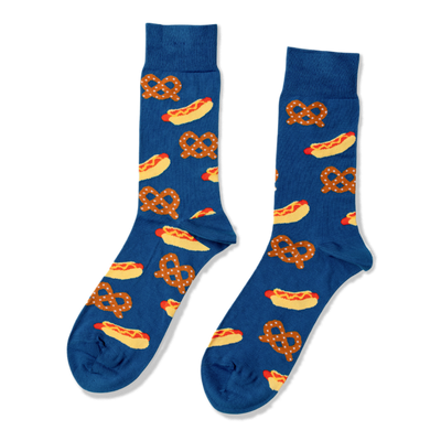 Pair of blue crew socks with a repeating pattern of yellow hot dogs with red sausages and mustard, and brown pretzels.