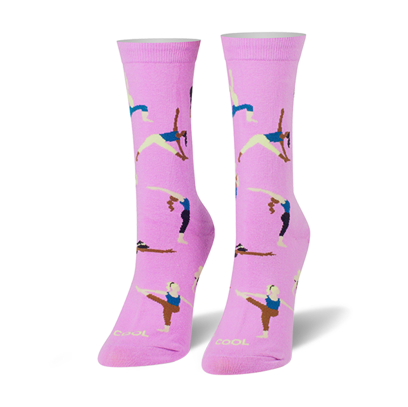 Pair of women's crew socks in light pink, featuring colorful illustrations of women in various yoga poses.