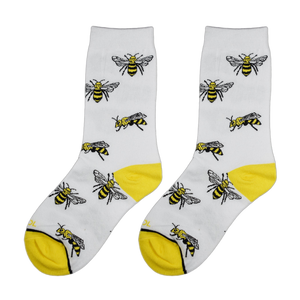 Close-up view of a pair of white socks with yellow bee illustrations.