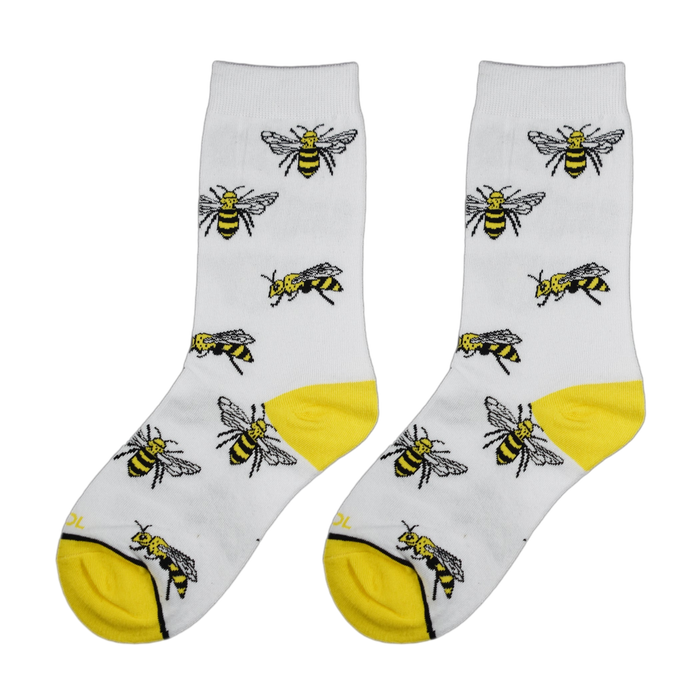 Close-up view of a pair of white socks with yellow bee illustrations.