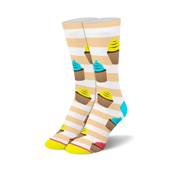 white crew socks designed for women featuring a pattern of yellow cupcakes with blue or pink frosting and light brown stripes. 