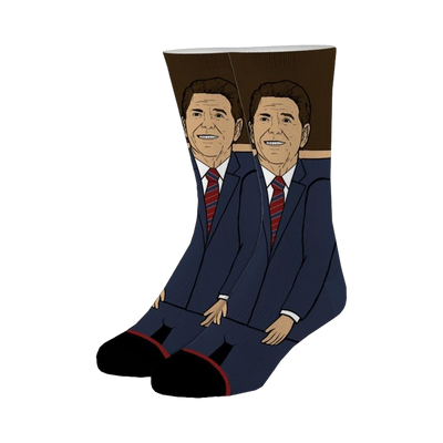 A pair of crew socks depicting Ronald Reagan in a navy suit and red tie.  The background is brown, and the design is illustrated.