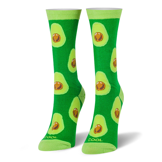Bright green crew socks covered in halved avocados with brown pits, featuring light lime green cuffs and toes. }}
