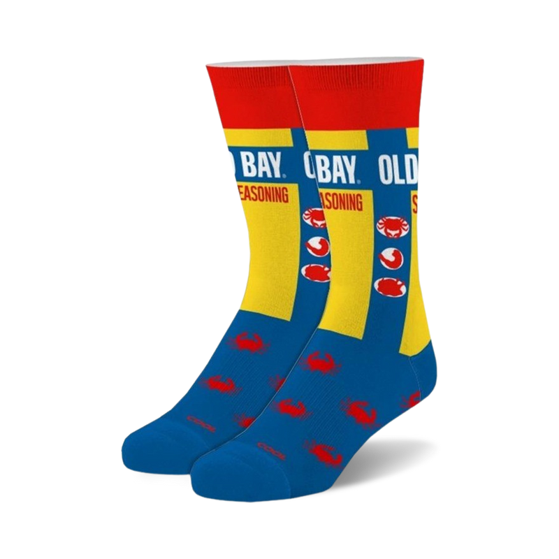 Pair of Old Bay crew socks. Blue and yellow design with Old Bay seasoning label and red crab illustrations.