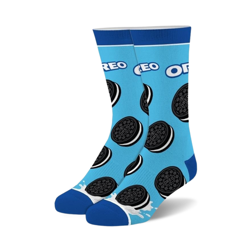 Pair of crew socks on light blue background, adorned with Oreo cookies and a milk splash at the bottom. Black and white Oreo design.