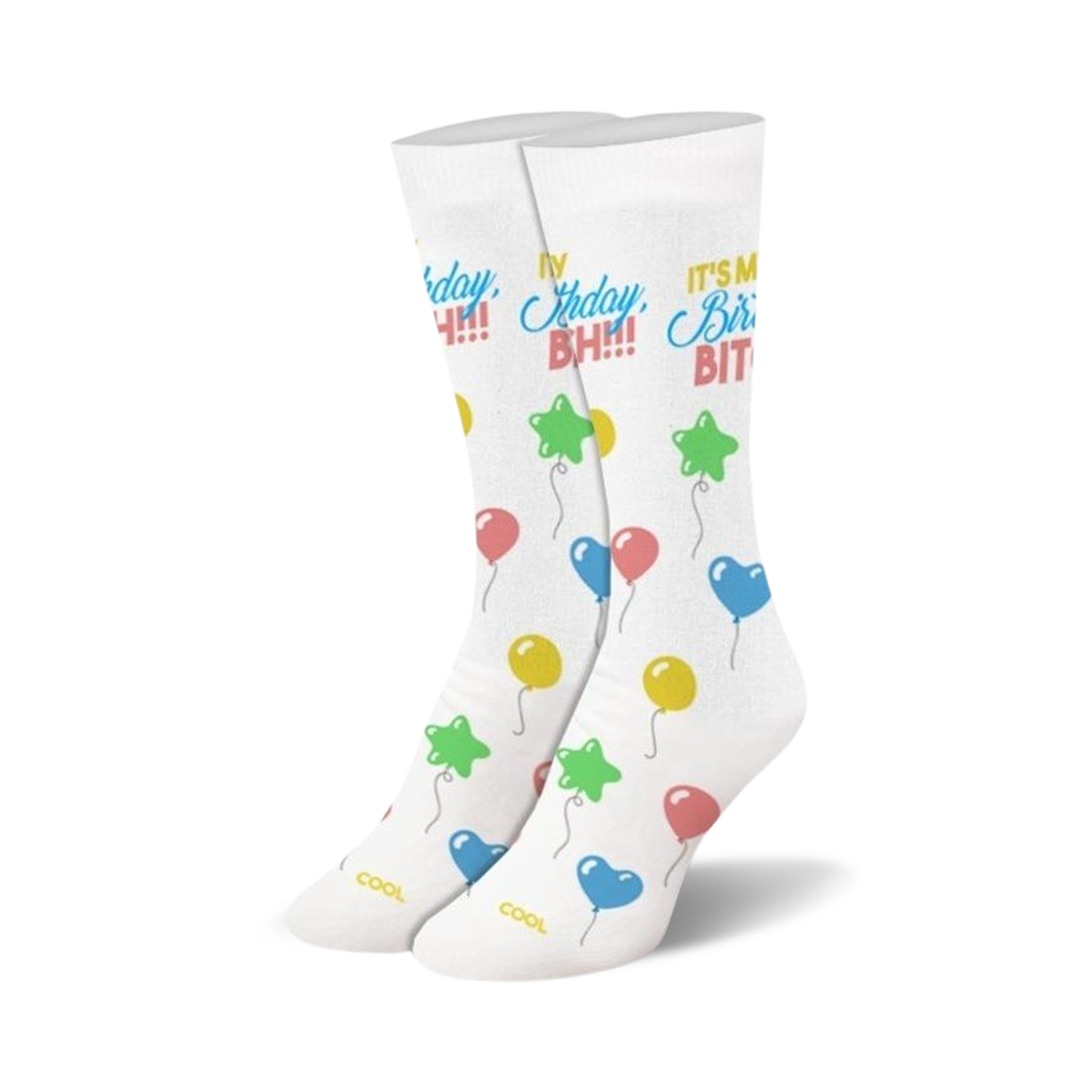 A pair of white crew socks with a 'Birthday Bitch!' slogan and colorful balloon illustrations.  Stars, hearts, and round balloons in pink, blue, yellow, and green.