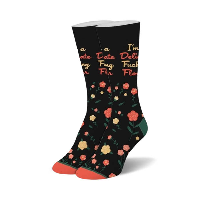 black crew socks with multicolored flowers and the bold statement 