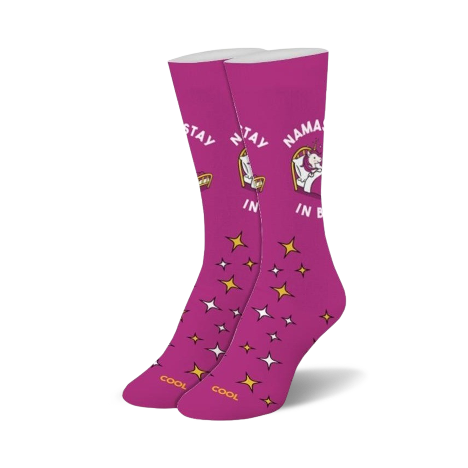 Pair of magenta crew socks with a whimsical unicorn design, gold stars, and the text 'Namastay In Bed'.