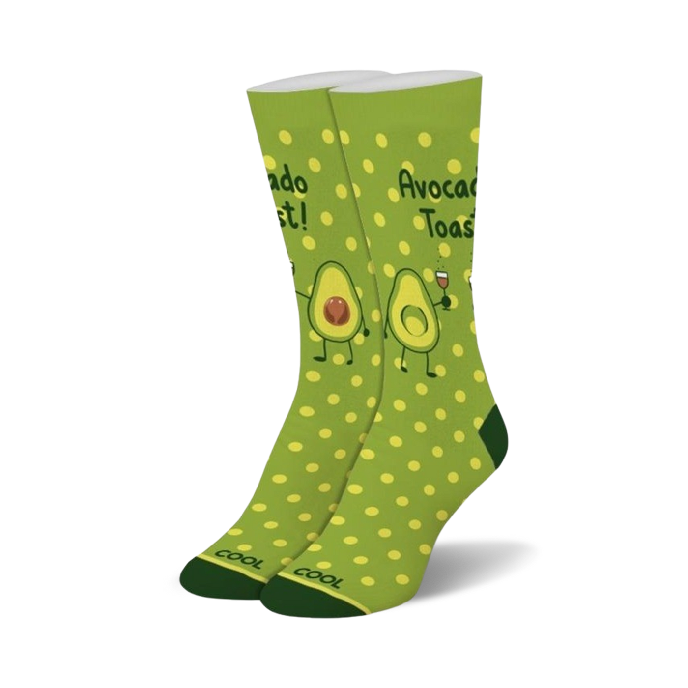 Pair of crew socks in green with yellow polka dots.  Features illustrations of avocados making a toast, with one holding a glass of wine.