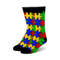 Pair of crew socks with a colorful puzzle piece design. The socks are primarily red, yellow, blue, and green, with black cuffs.