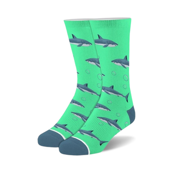 Pair of teal crew socks with a pattern of gray sharks and white bubbles. 