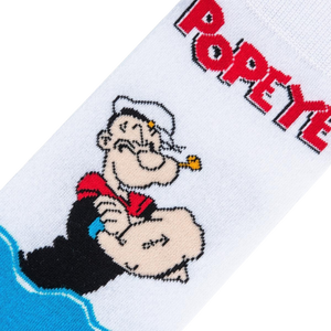 A white sock with a cartoon character, Popeye the Sailor Man, on the leg. He is wearing his signature white hat and red shirt with black sleeves. The sock is over a black background.
