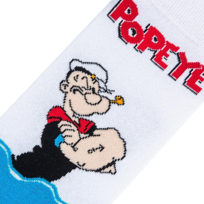 A white sock with a cartoon character, Popeye the Sailor Man, on the leg. He is wearing his signature white hat and red shirt with black sleeves. The sock is over a black background.