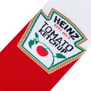 A pair of red socks with a white toe and heel and a green and white striped band around the ankle. The word 
