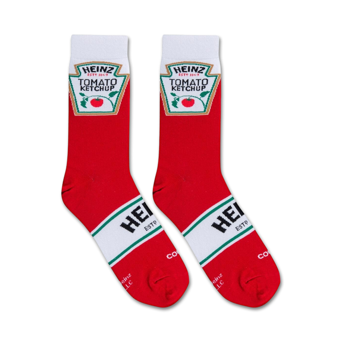 A pair of red socks with a white toe and heel and a green and white striped band around the ankle. The word 
