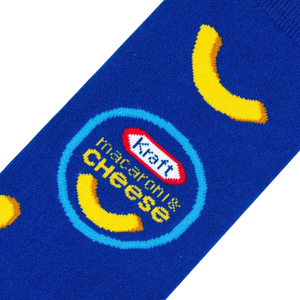 A blue sock with a pattern of yellow macaroni noodles and the Kraft Macaroni & Cheese logo.