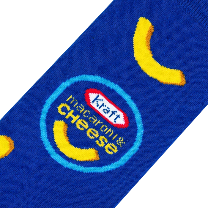 A blue sock with a pattern of yellow macaroni noodles and the Kraft Macaroni & Cheese logo.