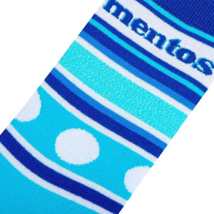 A blue sock with white polka dots and blue and white stripes with the word 