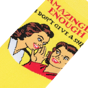 A yellow sock with a retro illustration of two women, one whispering to the other with text reading: 
