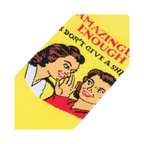 Close-up detail shot of the 'Amazingly Enough, I Don't Give A Shit' graphic on the yellow crew socks.