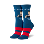 Pair of teal crew socks with red stripes and a retro-style illustration of a woman sipping tea. The text 'Sarcasm' and 'Now Served All Day!' is featured on the socks.