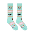 Flat lay of two mint green socks showing black and white cats, orange tabbies, brown cats, and pink stripes with paw prints.