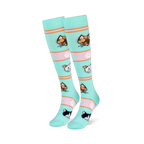 Mint green tall socks on foot models showing orange, brown, and tuxedo cat faces with pink striped bands and paw prints.