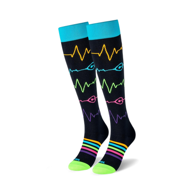Pair of black knee-high socks with colorful heart rate monitor and rainbow stripe designs.  Teal cuffs and lime green soles.