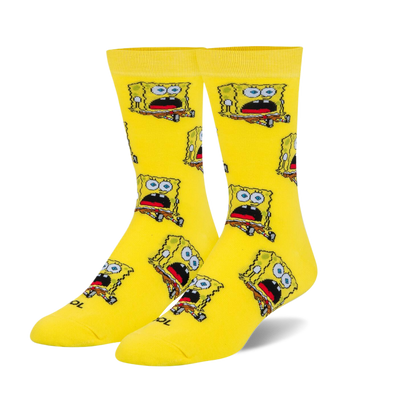 A pair of bright yellow crew socks with a repeating pattern of a square, yellow cartoon character with a surprised expression.
