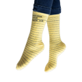 Lifestyle photo showing the yellow library card socks on a person's feet, jeans visible at the ankles.