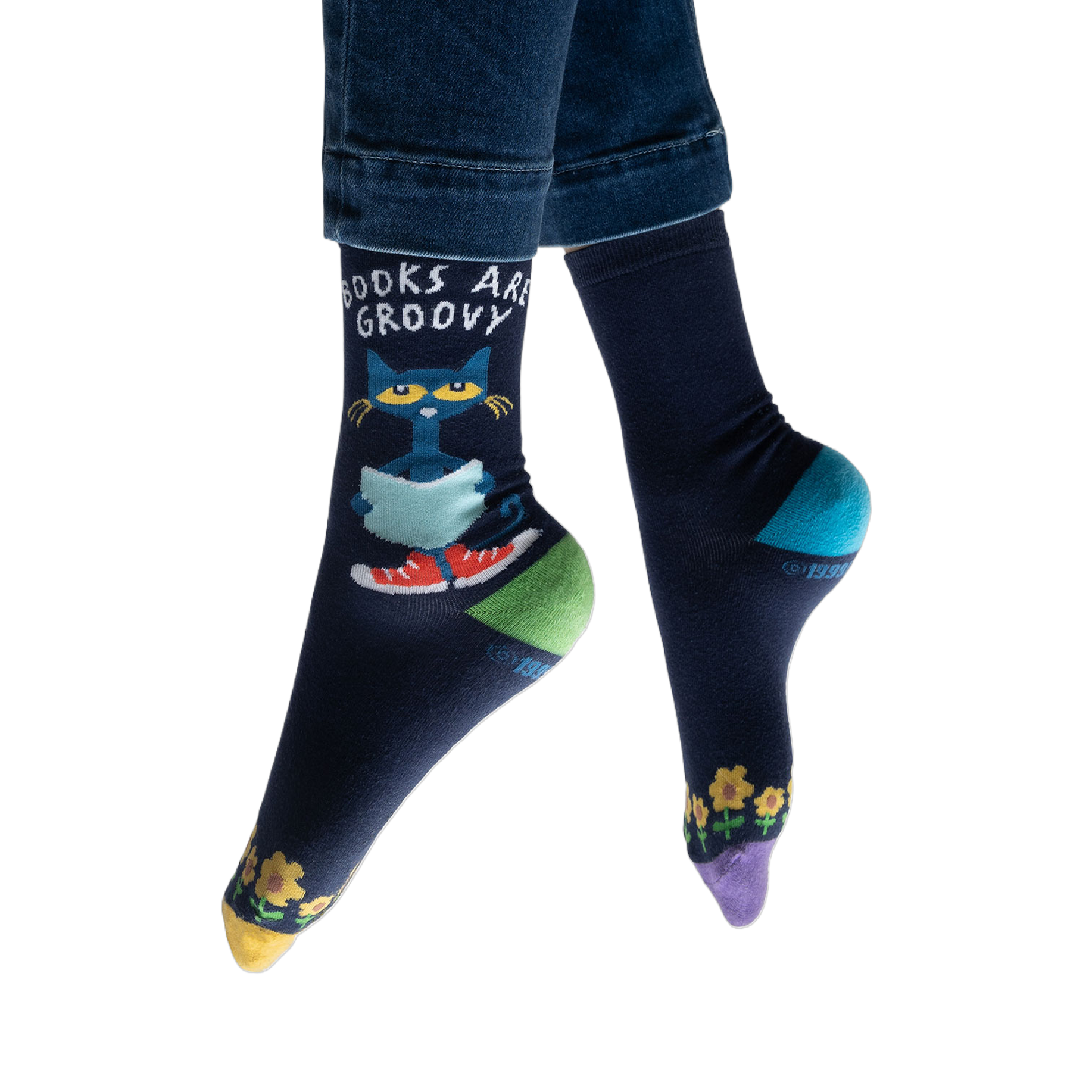 Lifestyle shot of model wearing Pete the Cat socks, showing how they look on feet with jeans.