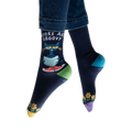 Lifestyle shot of model wearing Pete the Cat socks, showing how they look on feet with jeans.