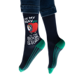 Lifestyle shot: Person wearing navy blue socks with teal stripes and a Richard Scarry apple car design.