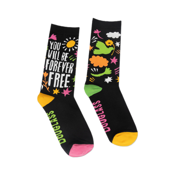 front view of a pair of black adult socks with colorful designs, one sock says "you will be forever free" and the other has flowers and a bird.