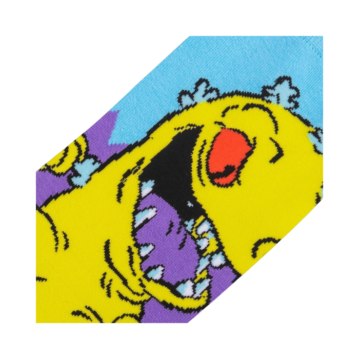 Close-up detail shot of the Reptar design on the Rugrats socks, showing the texture and colors.